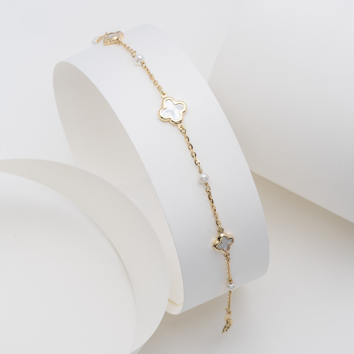 Mother of Pearl Four Leaf Clover Bracelet featuring three clover designs and four pearls.