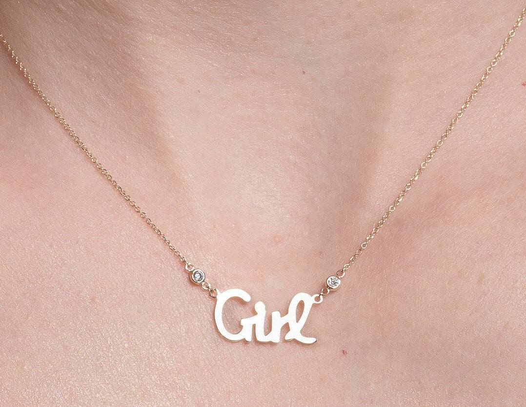 Girl Necklace in 14k gold with two cubic zirconia stones worn by a model 