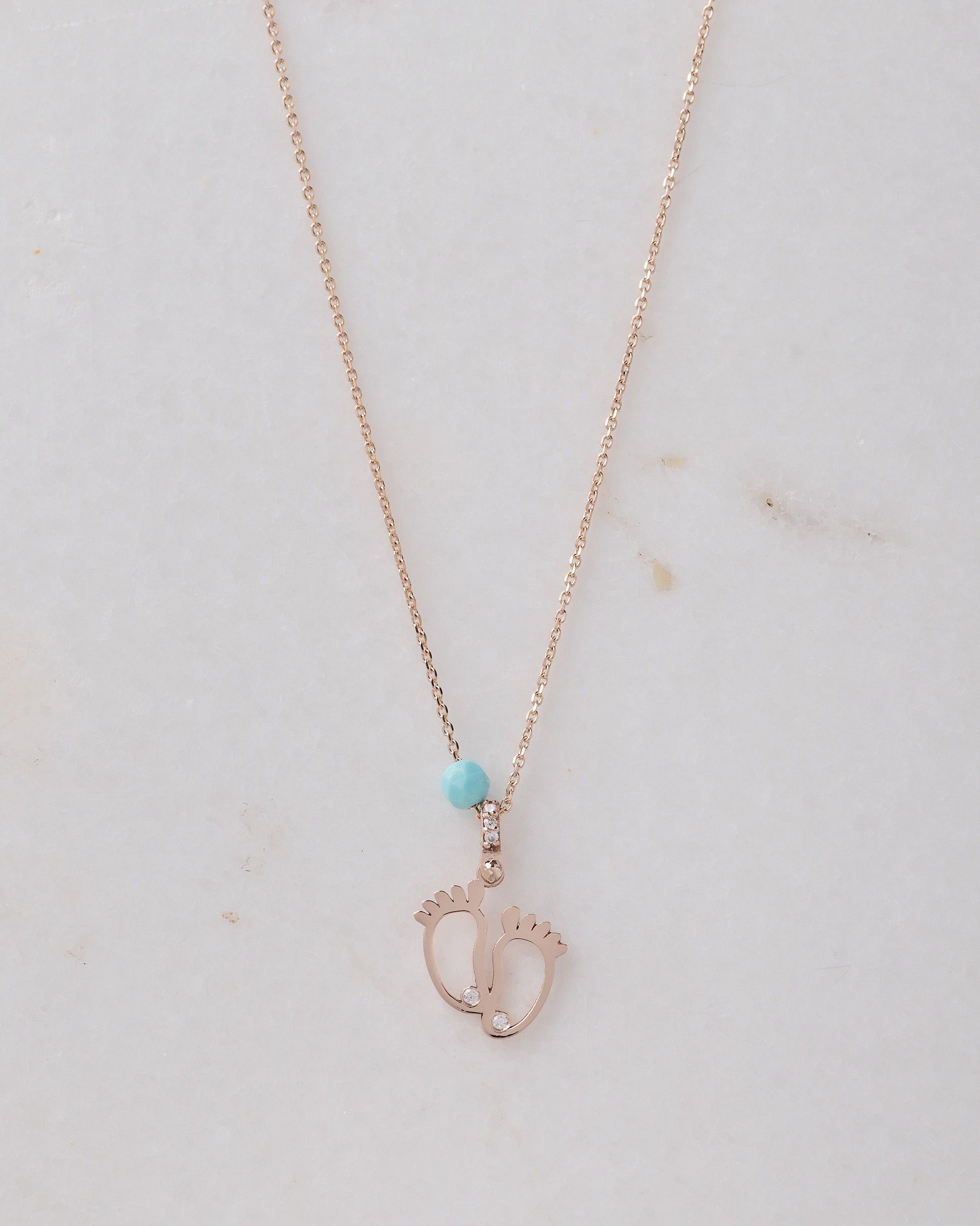 baby footprint necklace in 14k gold with cubic zirconia and turquoise stone