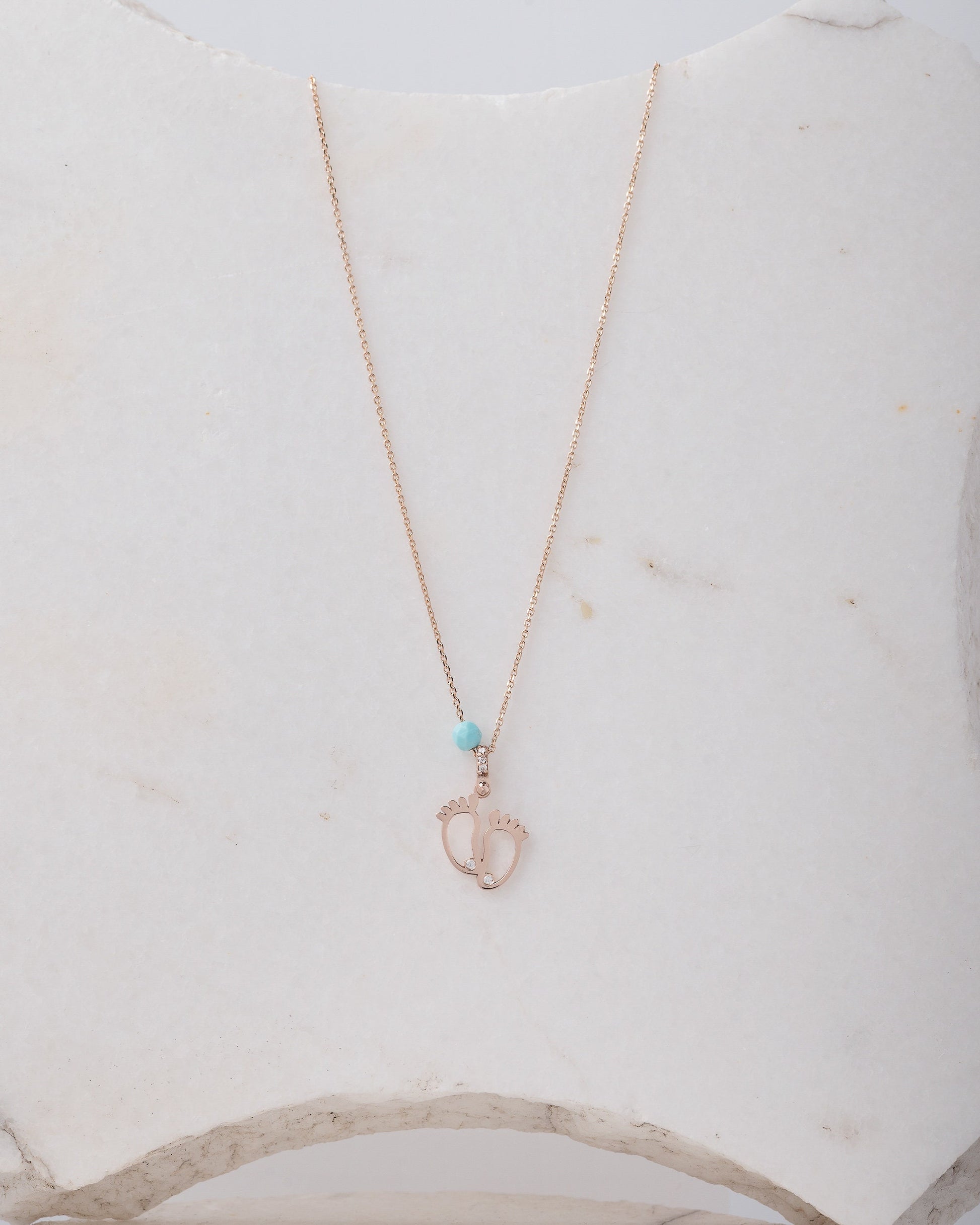 baby footprint necklace in 14k gold with cubic zirconia and turquoise stone