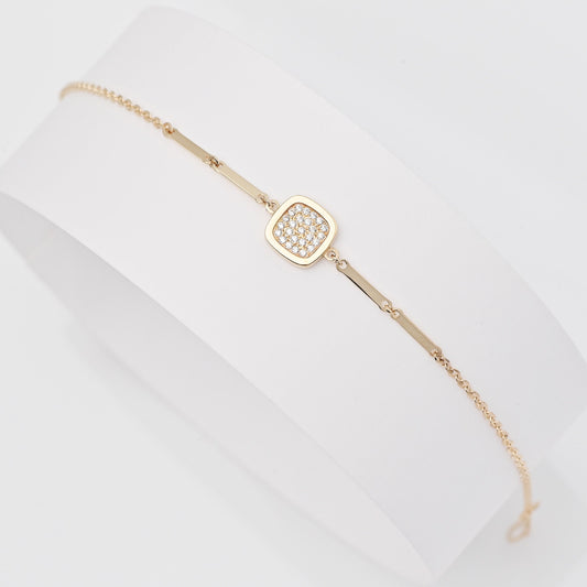 a  14k gold charm bracelet with a square charm paved with white cubic zirconia stones