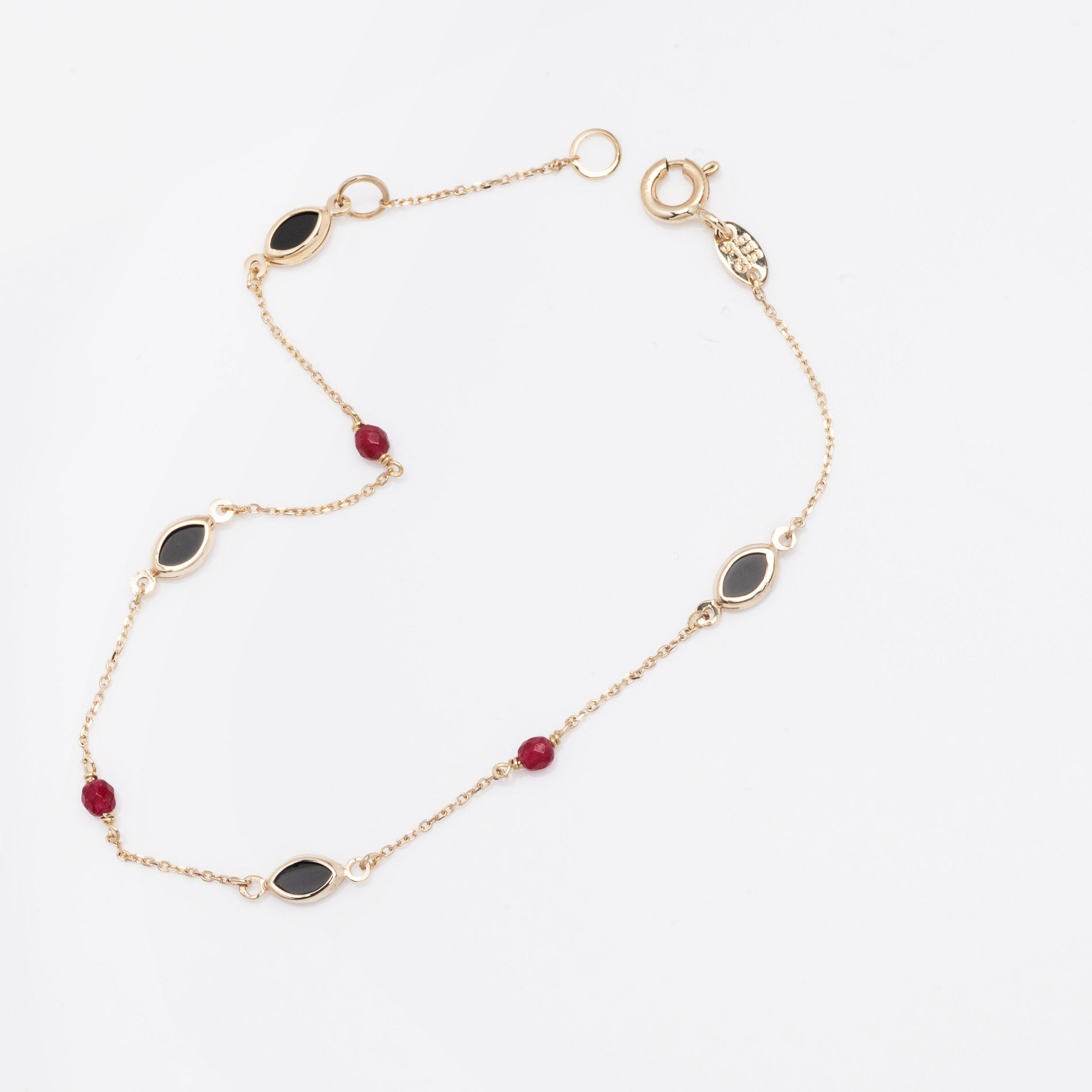 a 14k gold station bracelet with onyx and tourmaline for women 