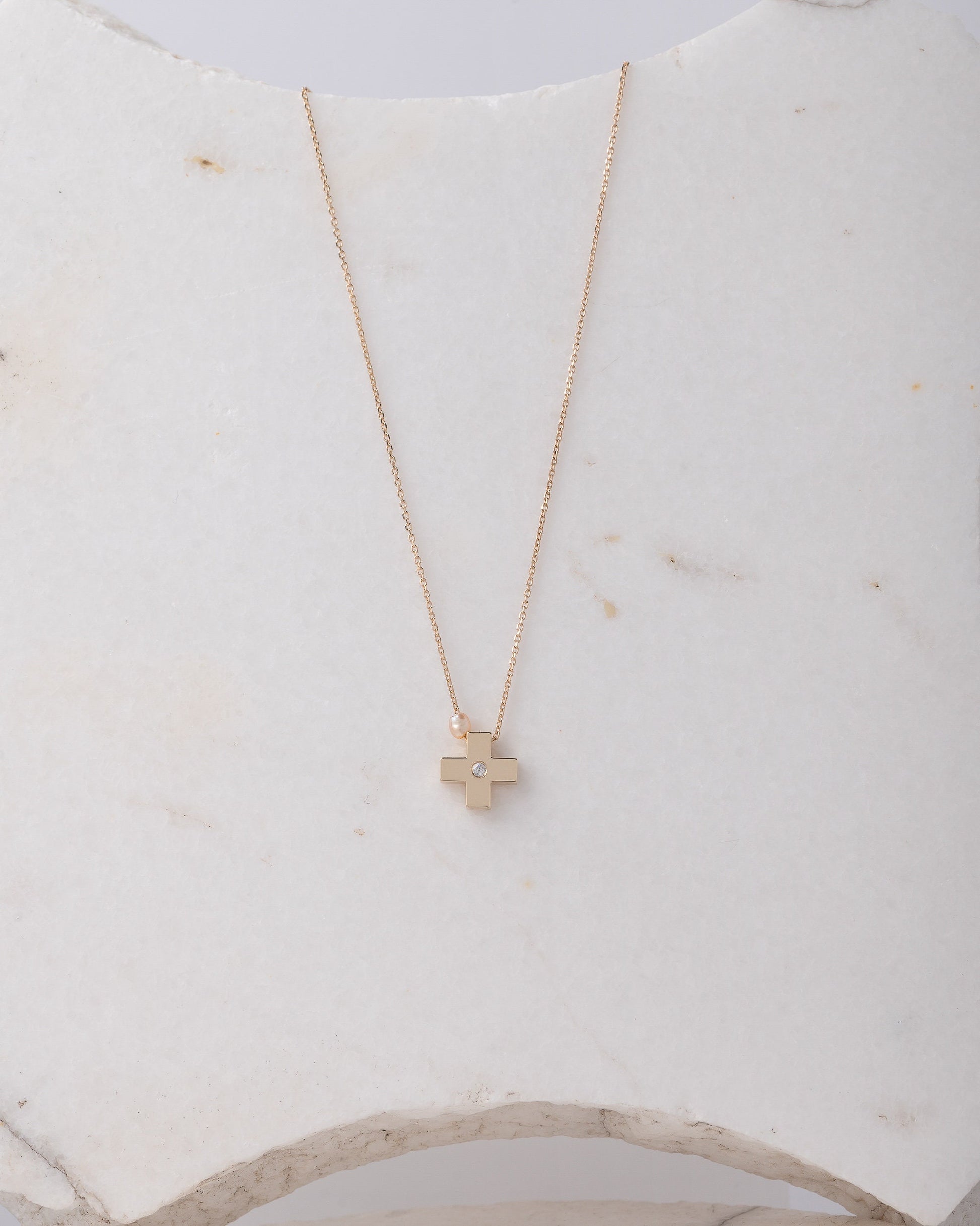 small diamond cross necklace with a small pearl in 14k yellow gold for women 