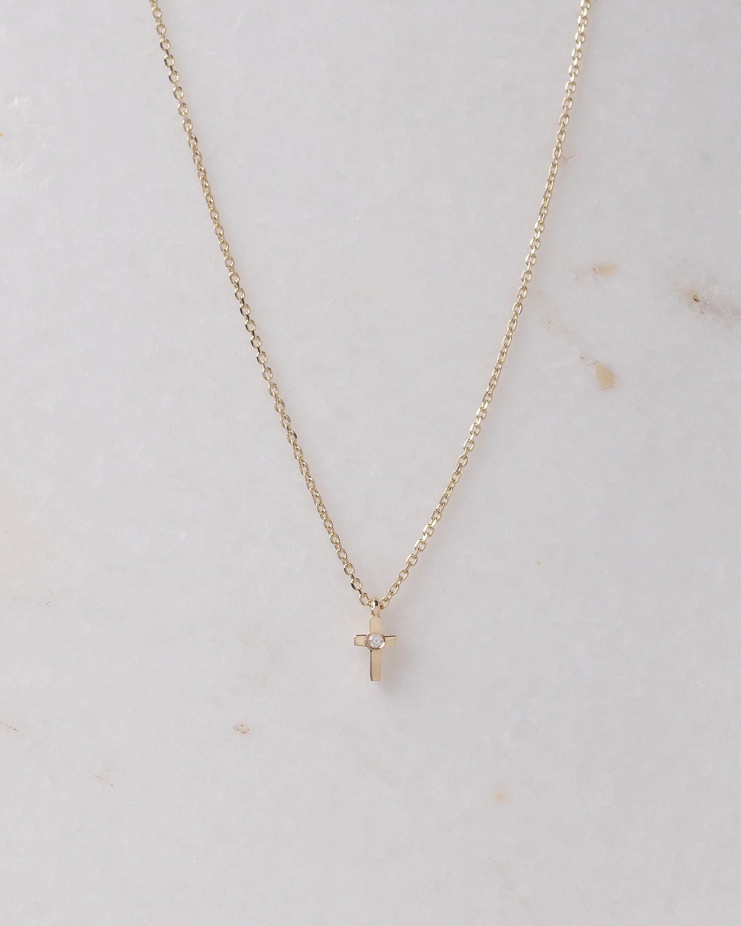 tiny diamond cross necklace in 14k yellow gold