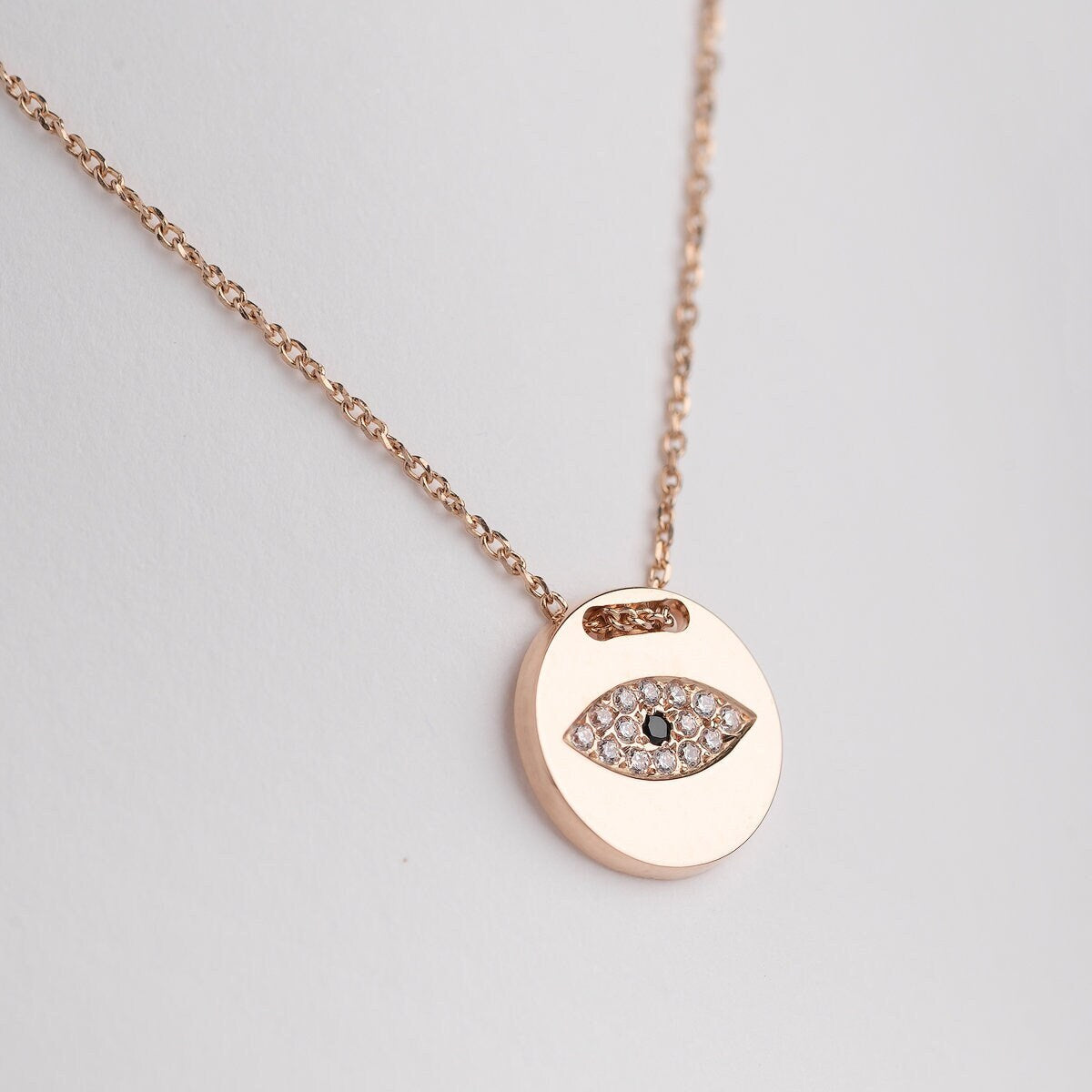 Pavé evil eye necklace in 14k yellow gold for women.