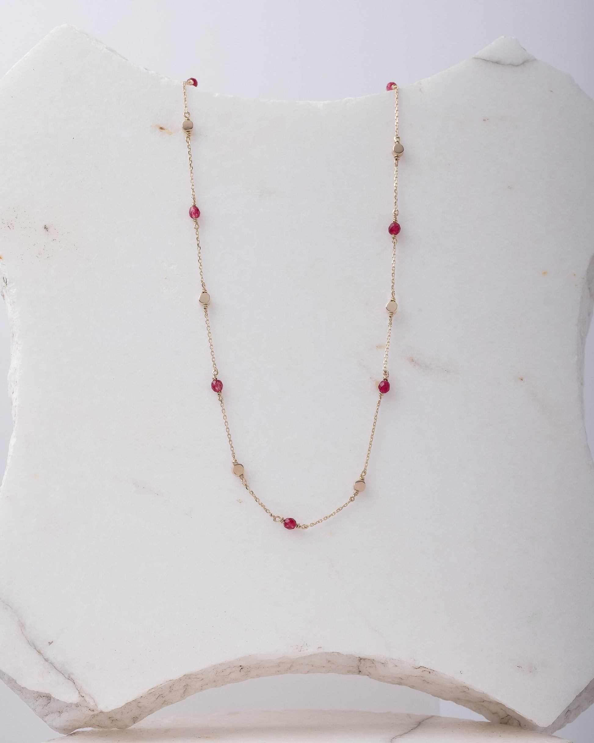 Station necklace featuring gold beads and tourmaline stones set in 14k gold.