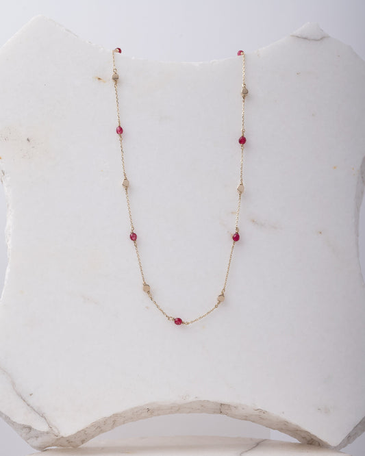 Station necklace featuring gold beads and tourmaline stones set in 14k gold.