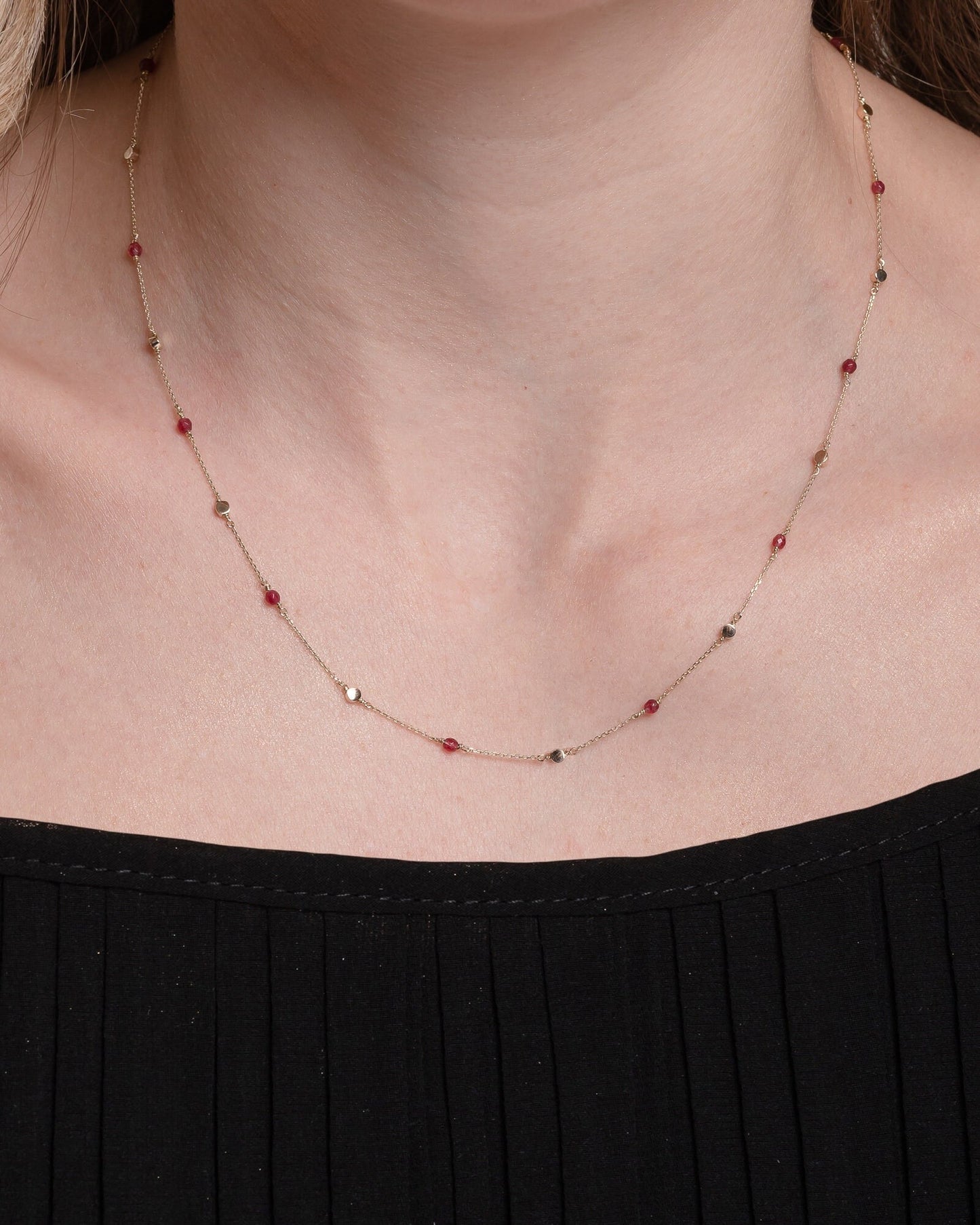 Station necklace featuring gold beads and tourmaline stones set in 14k gold.