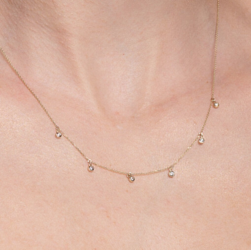 A model wearing a Cubic Zirconia By The Yard Station Necklace in 14k gold