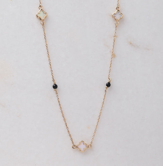 Mother-of-pearl clover necklace with onyx beads in 14k gold.