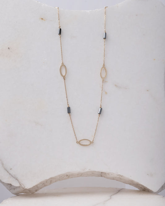 A station necklace adorned with oval patterns and bloodstone beads, crafted in 14k gold for women.