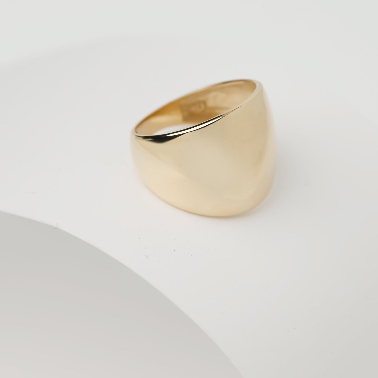 A large dome-shaped signet ring for women, crafted in 14k gold.