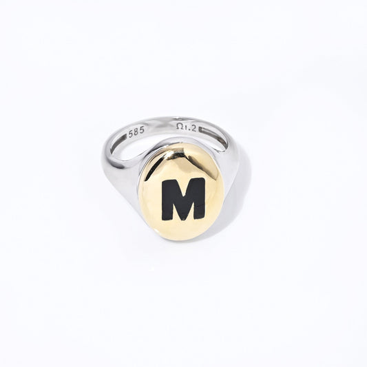 A two-tone monogram signet ring in 14k gold with enamel accents for women.