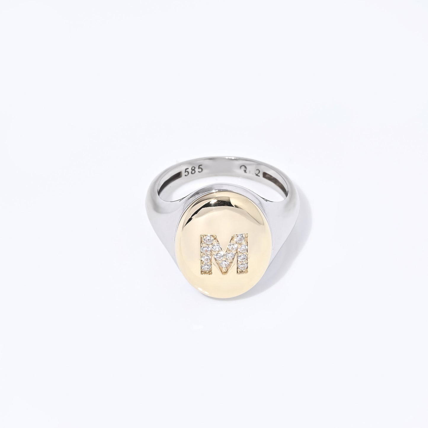 A two-tone monogrammed signet ring adorned with cubic zirconia stones, crafted in 14k gold for women.