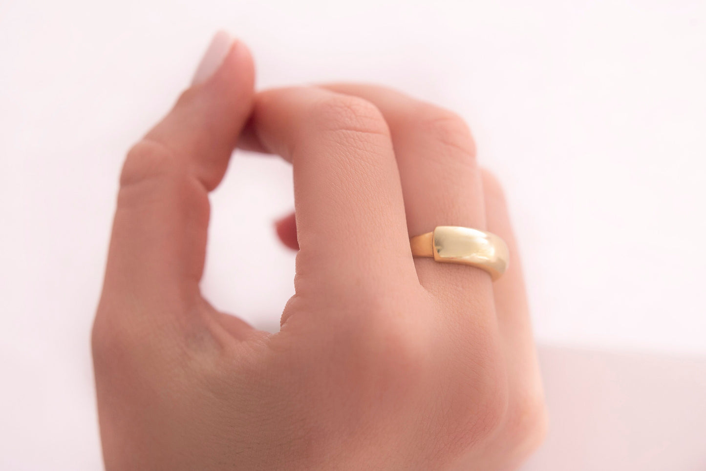 A dome ring for women crafted in 14k gold.