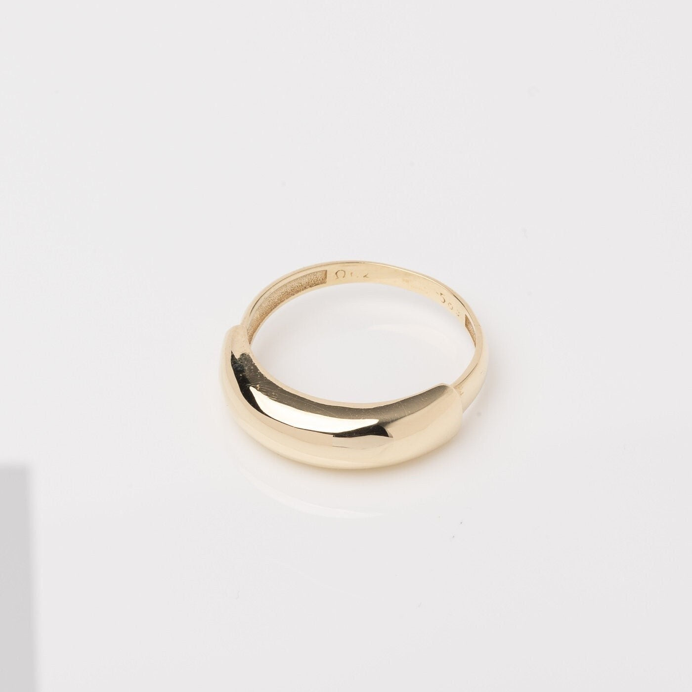 A dome ring for women crafted in 14k gold.