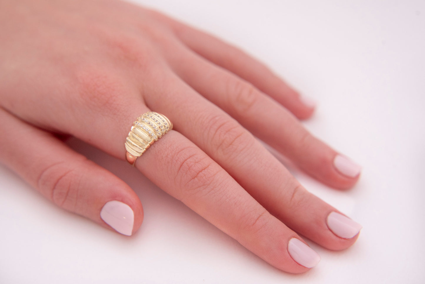 A Croissant Ring adorned with white cubic zirconia stones, set in 14k gold for women.