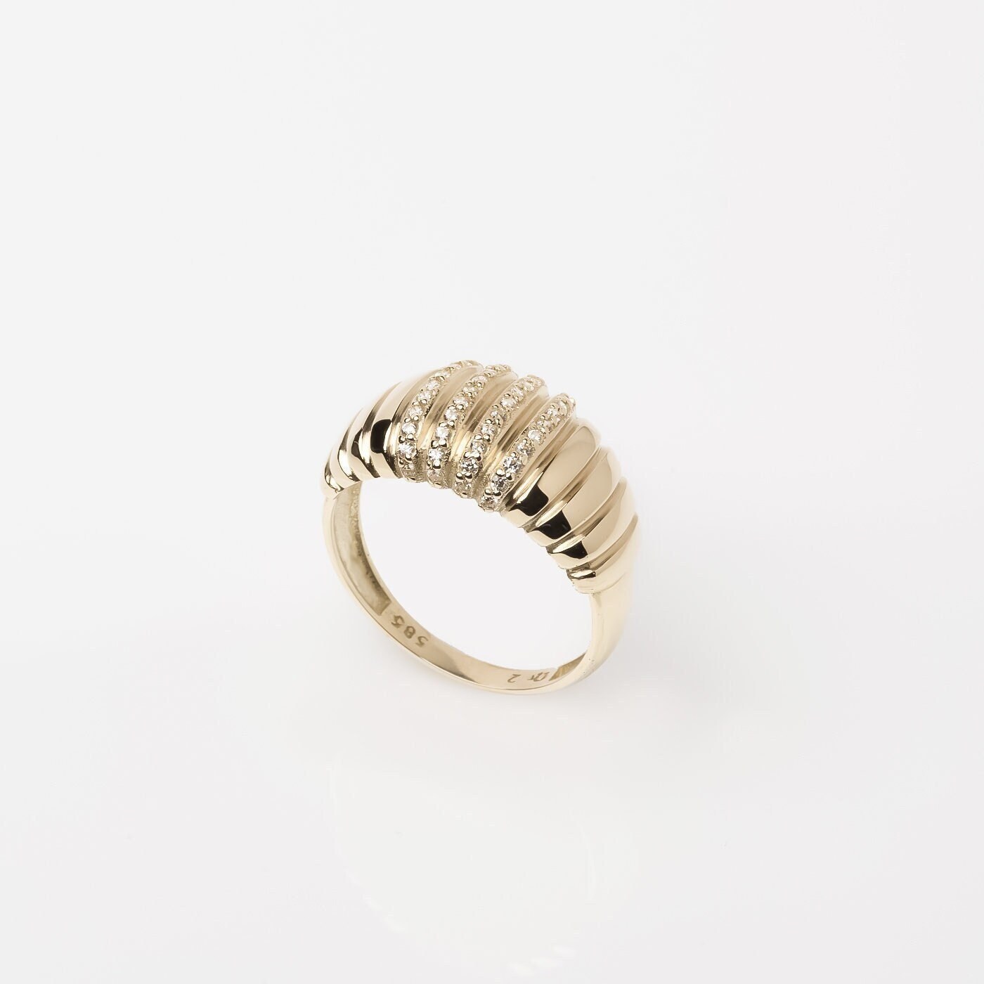 A Croissant Ring adorned with white cubic zirconia stones, set in 14k gold for women.