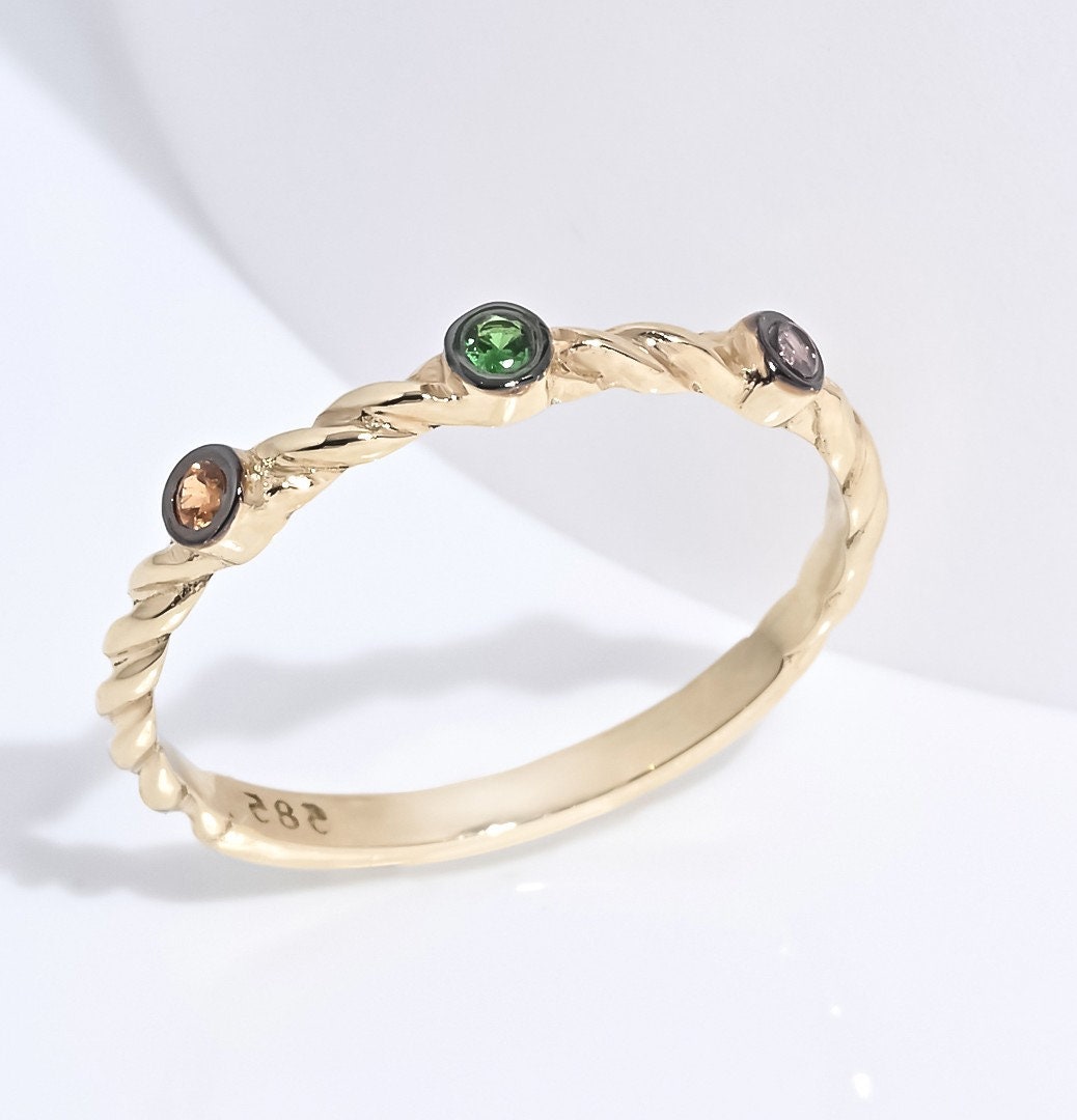 Triple-stone twisted ring in 14k solid gold with semi-precious stones.