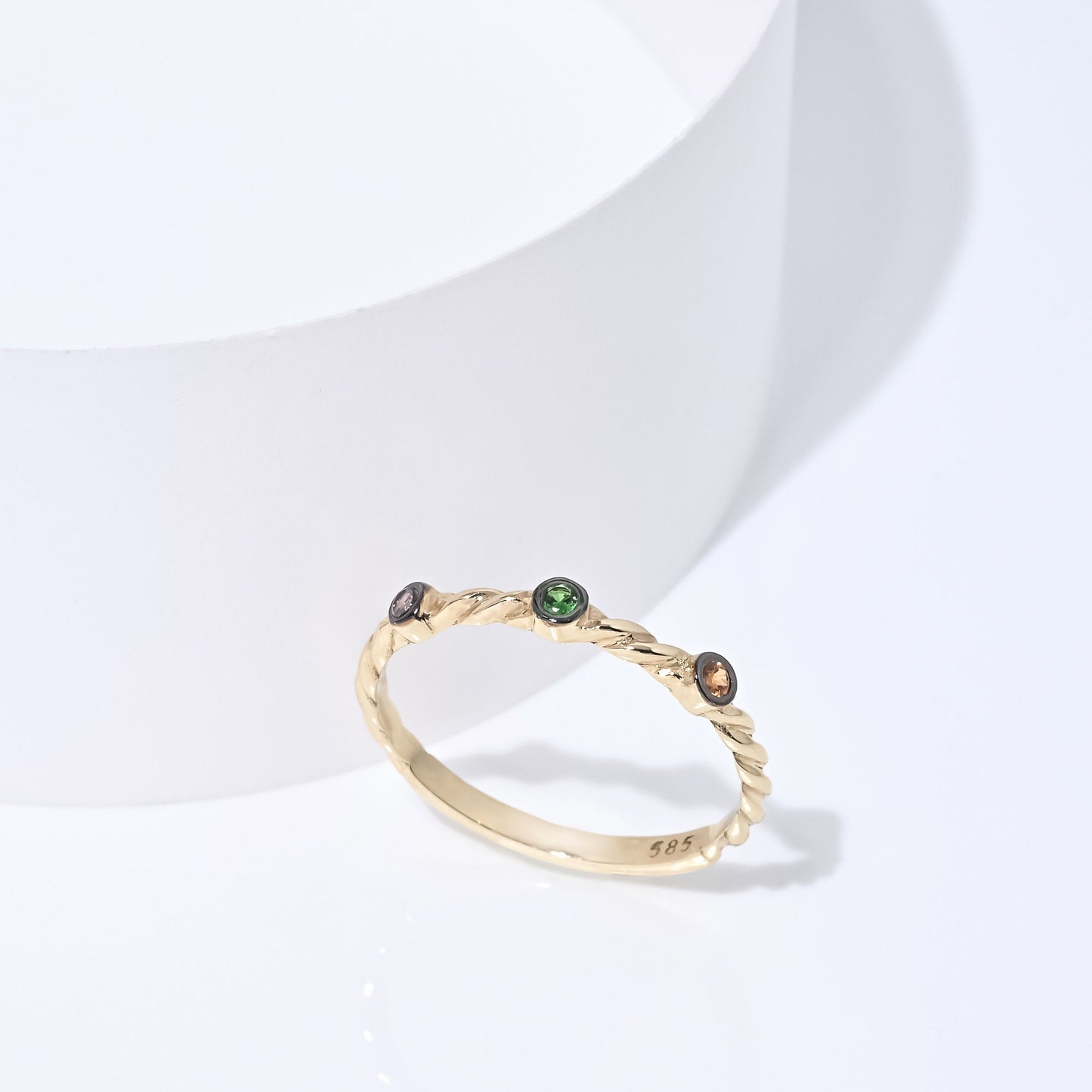 Triple-stone twisted ring in 14k solid gold with semi-precious stones.