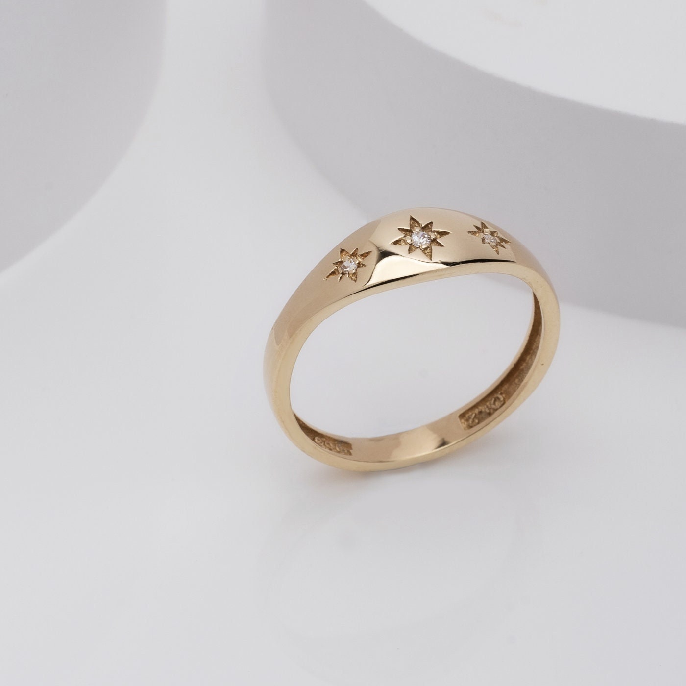 Handcrafted 14k gold starburst ring featuring three stars, designed for women.