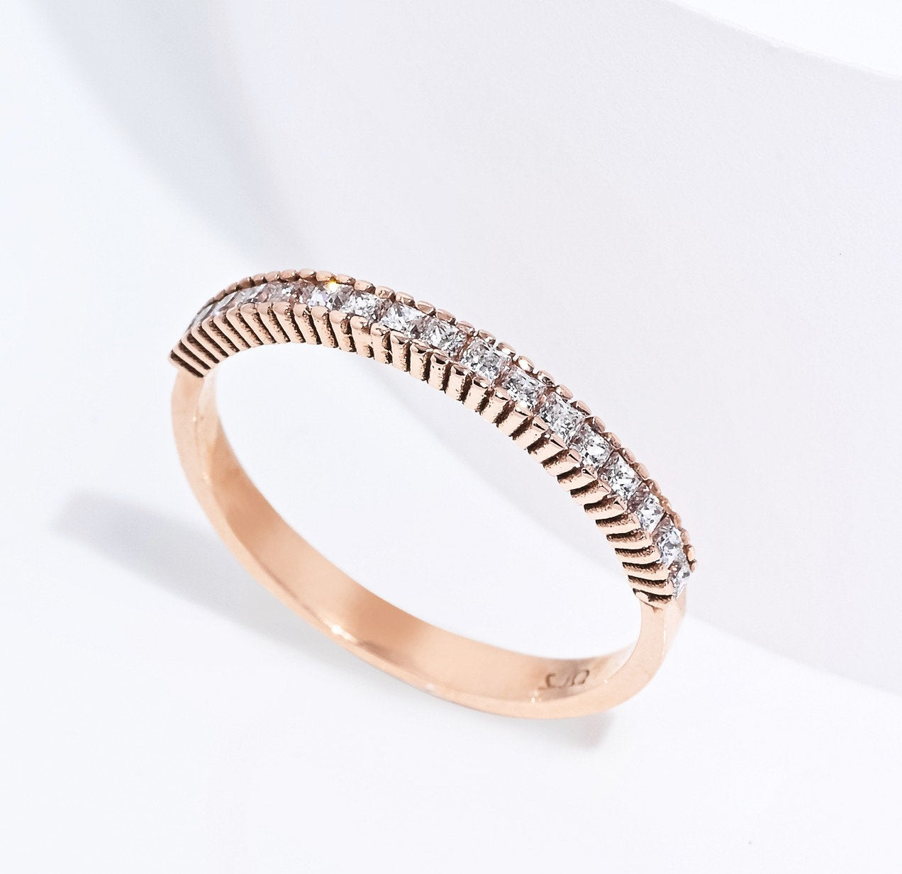 A half eternity band ring crafted in 14k solid gold, featuring white cubic zirconia stones in a prong setting.