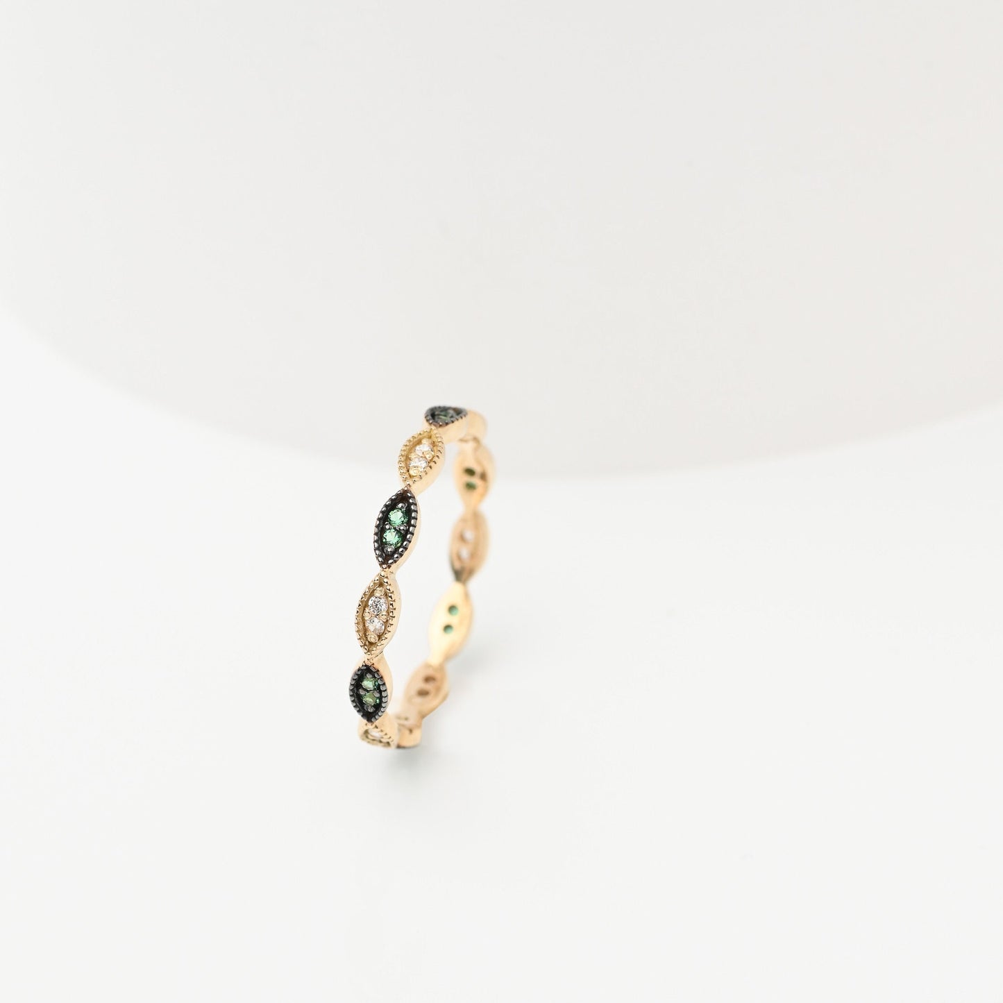 Handmade full eternity ring featuring white and green cubic zirconia stones set in 14k solid gold.