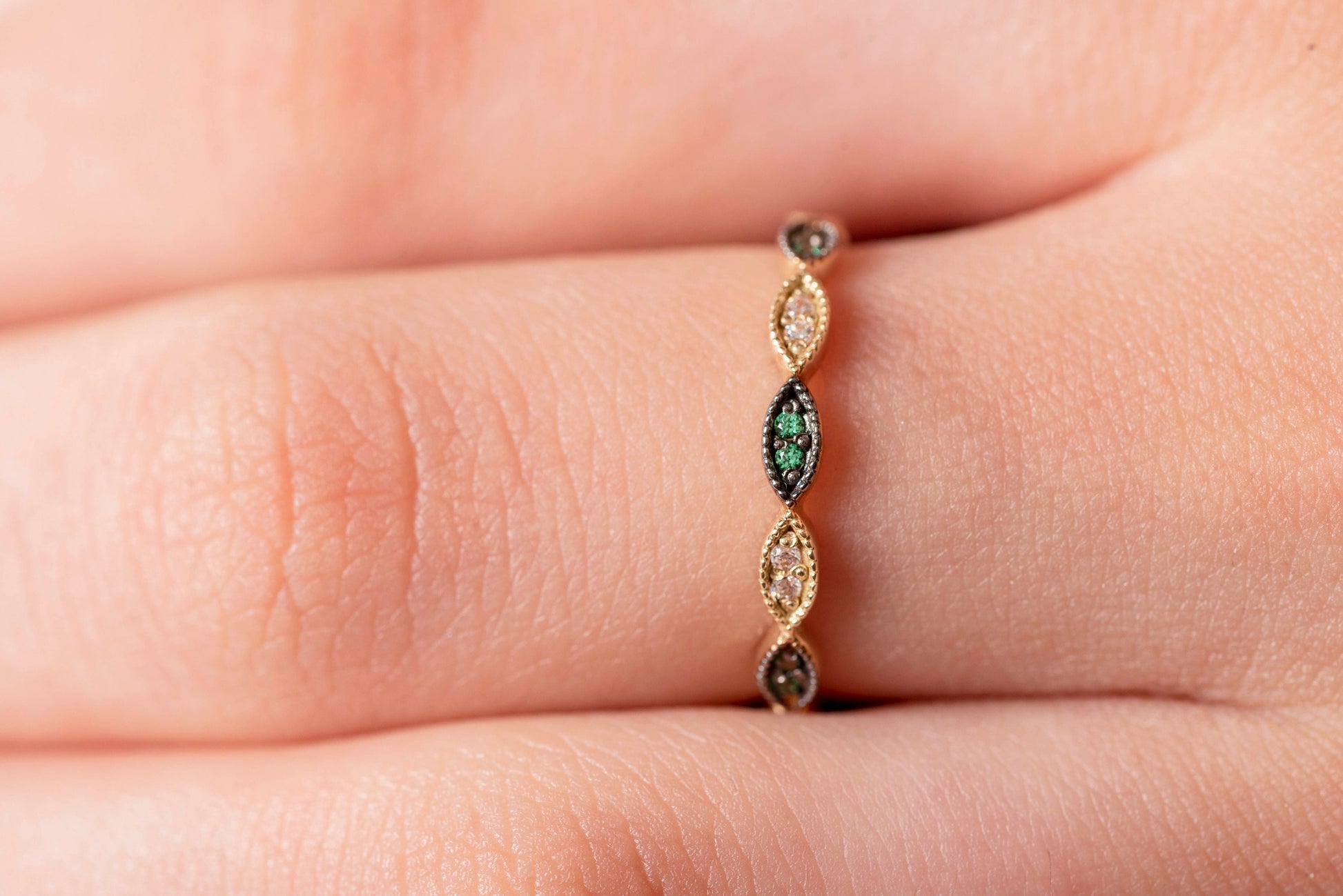 Handmade full eternity ring featuring white and green cubic zirconia stones set in 14k solid gold.