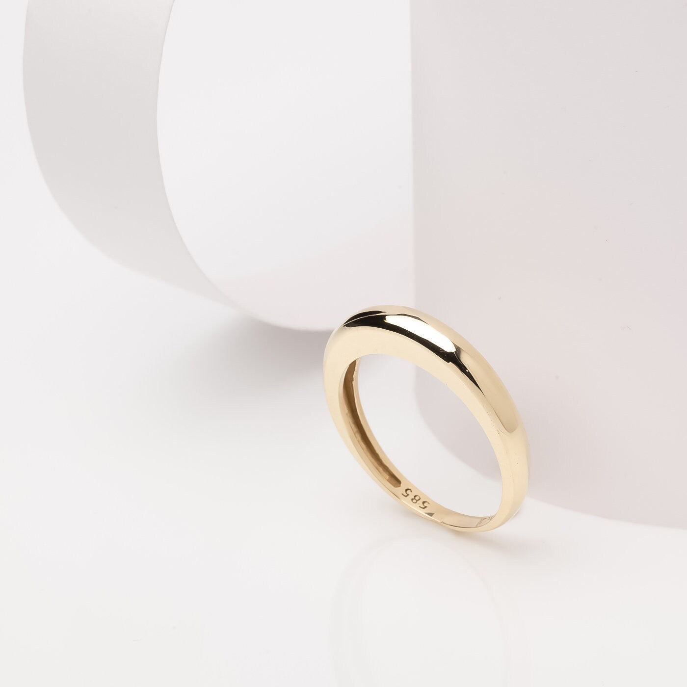 A thin dome ring made of 14k solid gold for women.