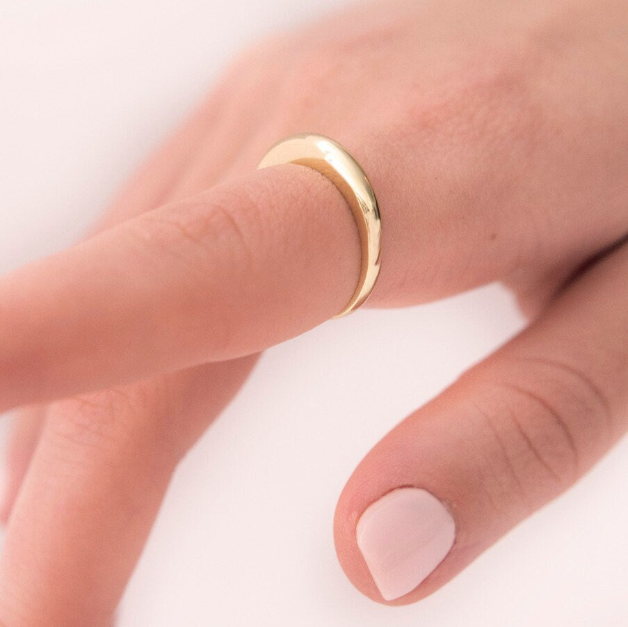 A thin dome ring made of 14k solid gold for women.