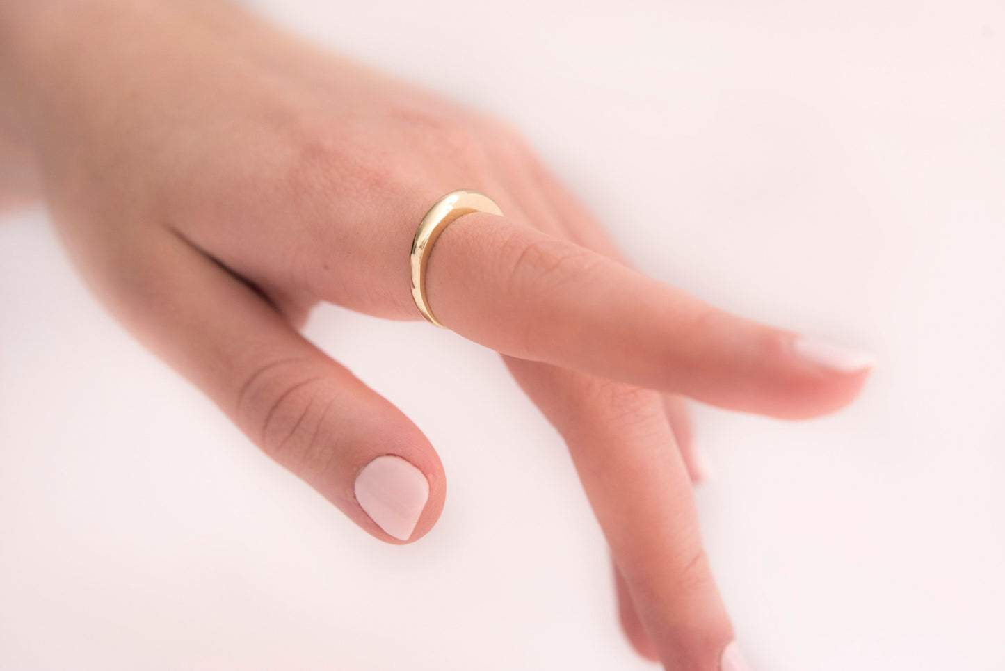 A thin dome ring made of 14k solid gold for women.