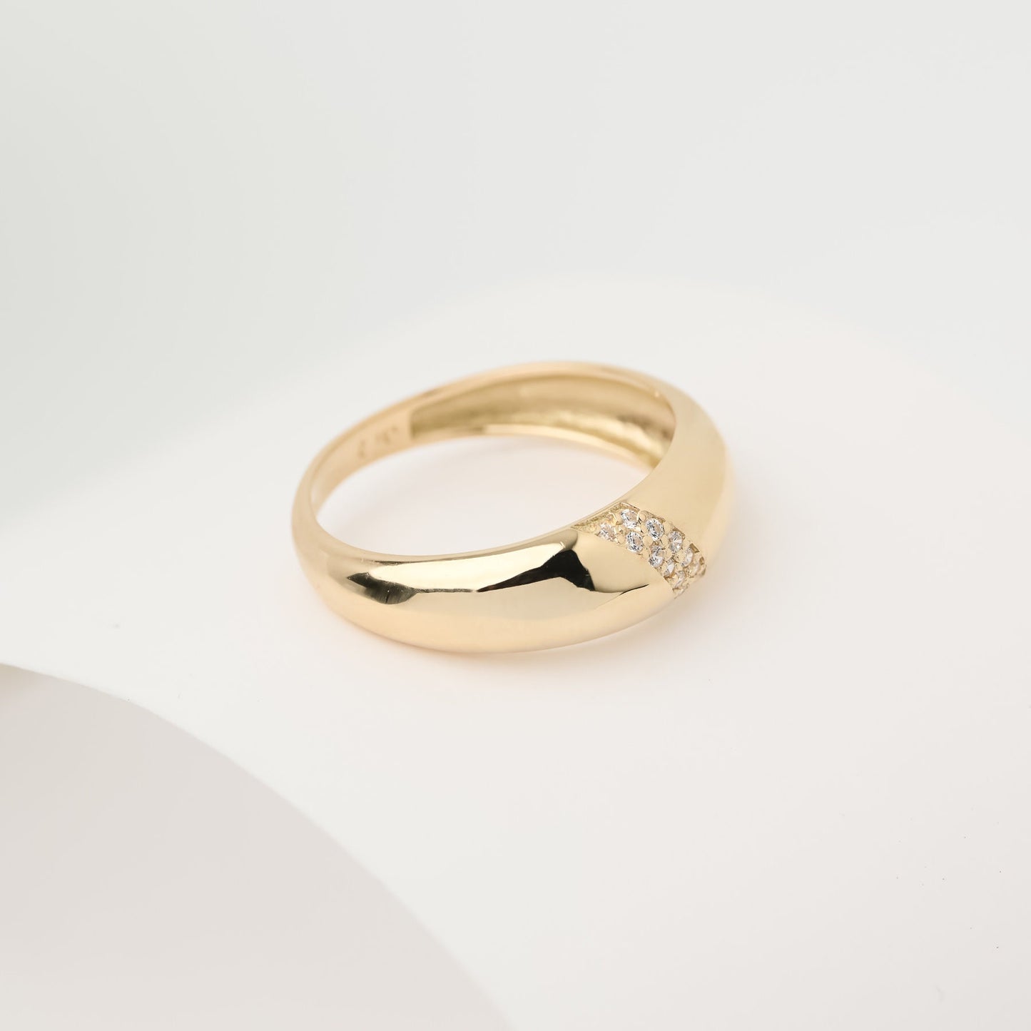 Handmade dome ring in 14k solid gold, partially paved with white cubic zirconia stones.