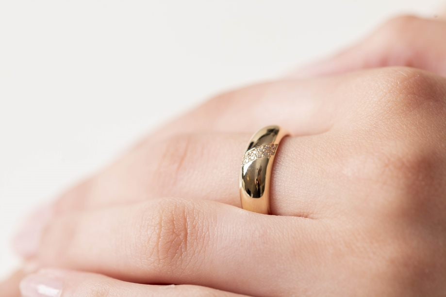 Handmade dome ring in 14k solid gold, partially paved with white cubic zirconia stones.