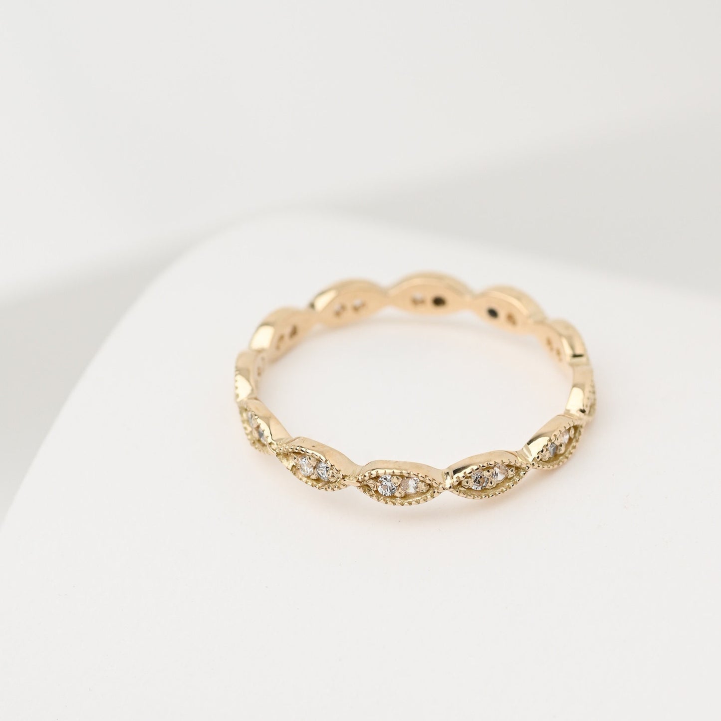 Handmade Eretiny band ring crafted in 14k gold, adorned with white cubic zirconia stones.