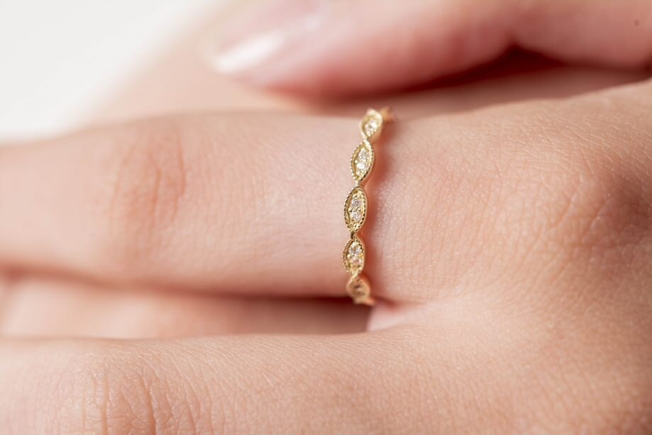 Handmade Eretiny band ring crafted in 14k gold, adorned with white cubic zirconia stones.