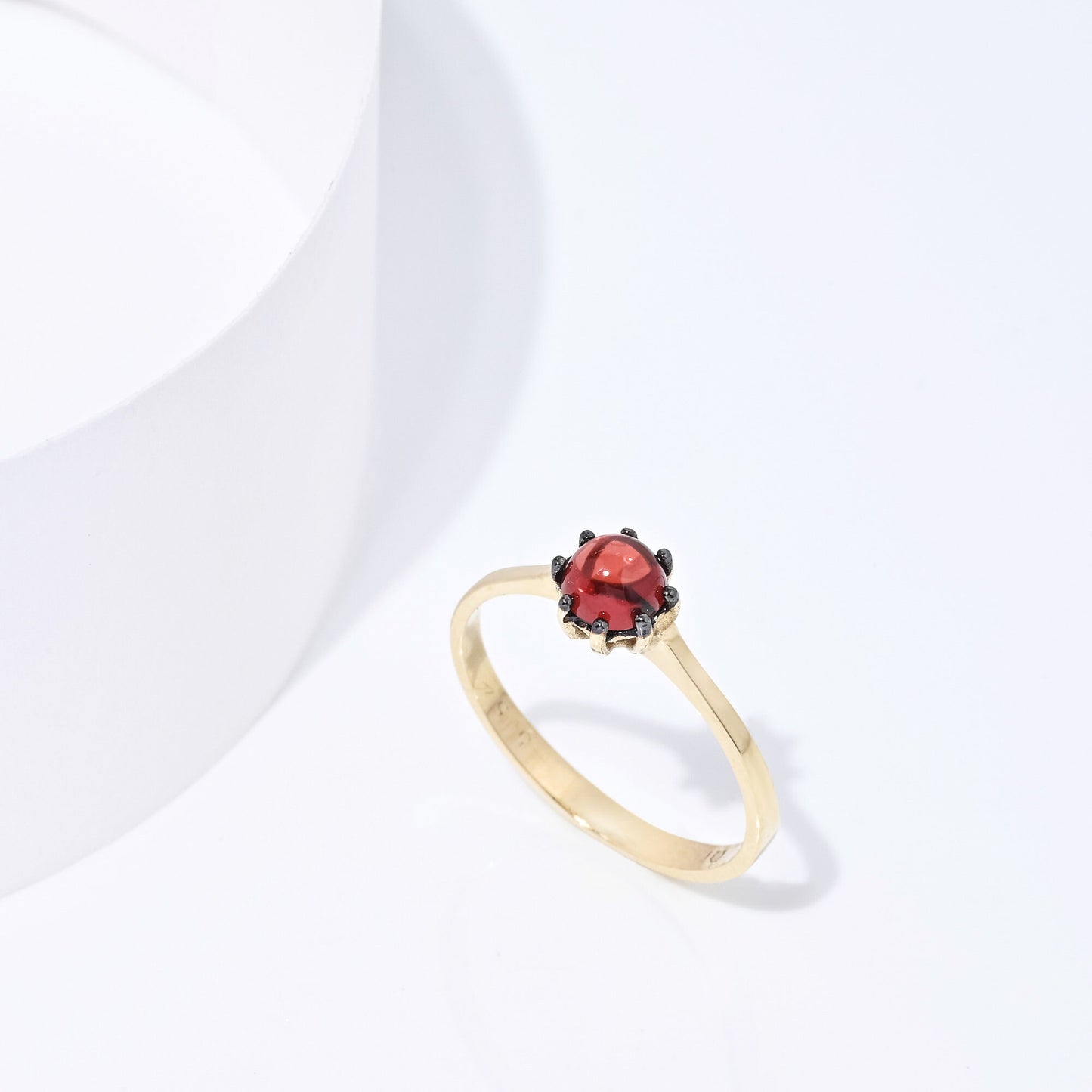 A natural garnet ring set in a 14k solid gold prong setting, designed for women.