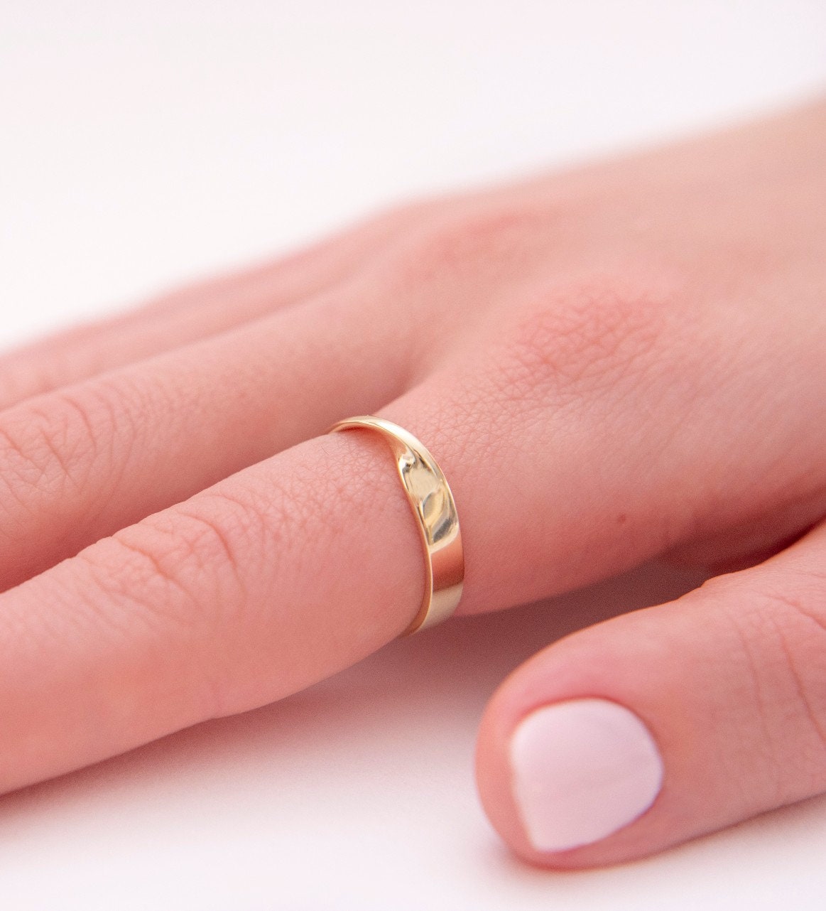 Thick Möbius ring in 14k solid gold for women.