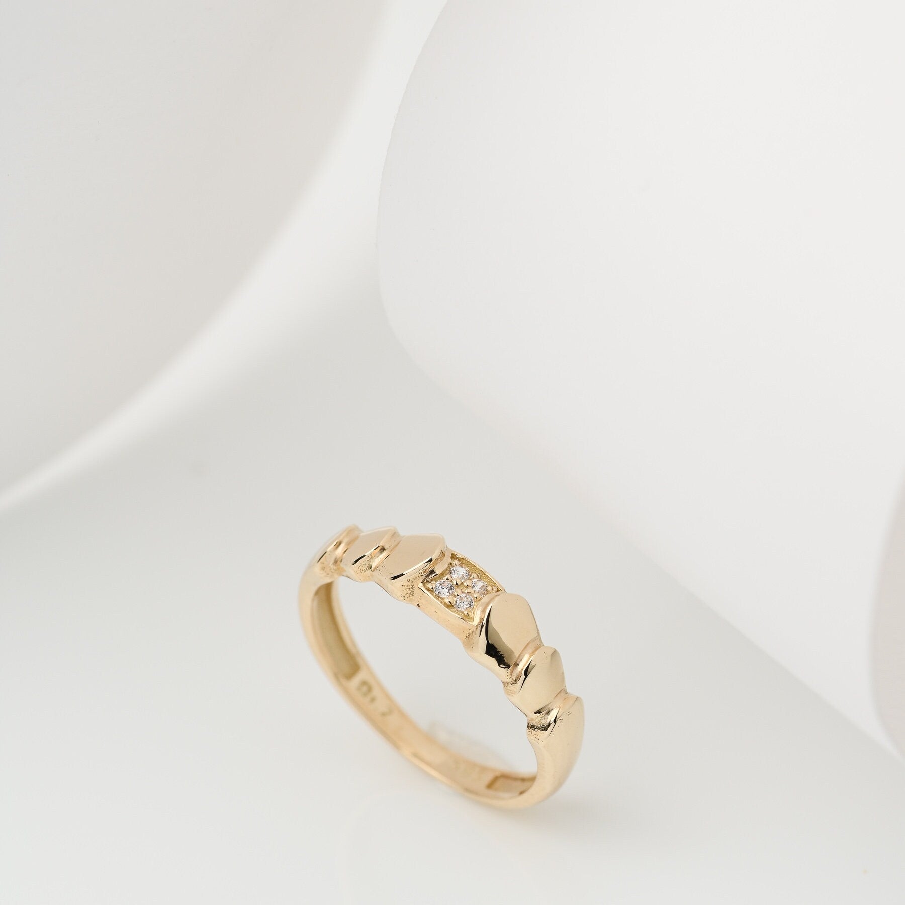 Handmade wrapped ring in 14k solid gold, the top part of the ring is encrusted with white cubic zirconia stones.