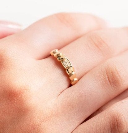 Handmade wrapped ring in 14k solid gold, the top part of the ring is encrusted with white cubic zirconia stones.