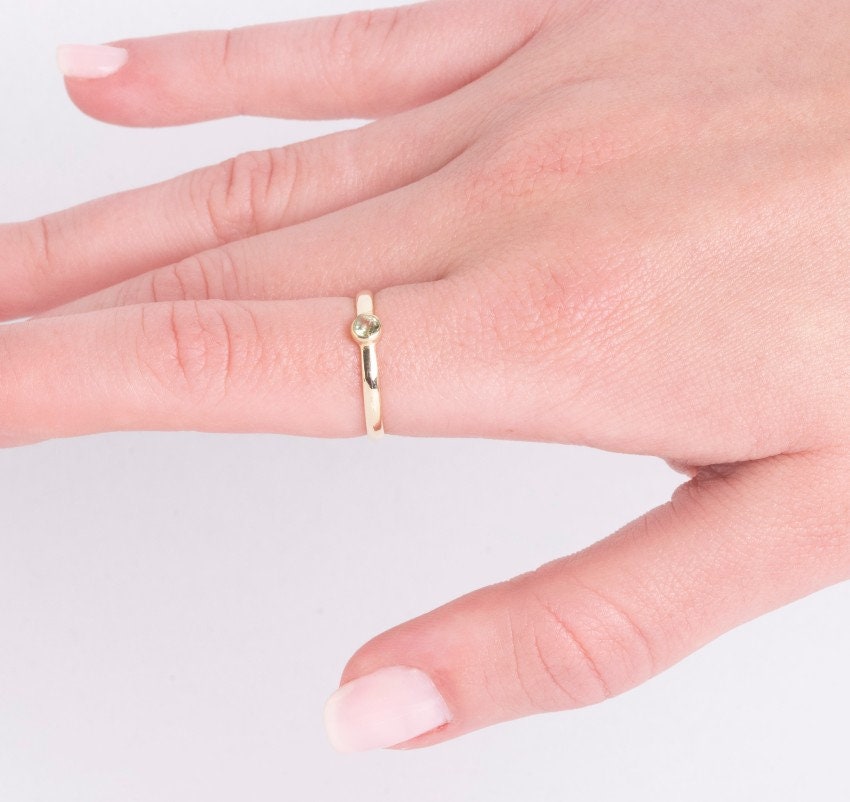 A handmade birthstone ring crafted in 14k solid gold, featuring a single stone in a bezel setting.