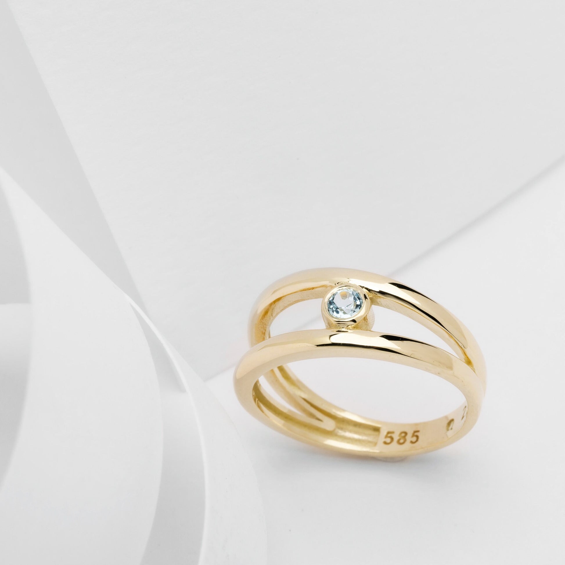 A handmade, double-row birthstone ring set in 14k gold with a bezel setting.