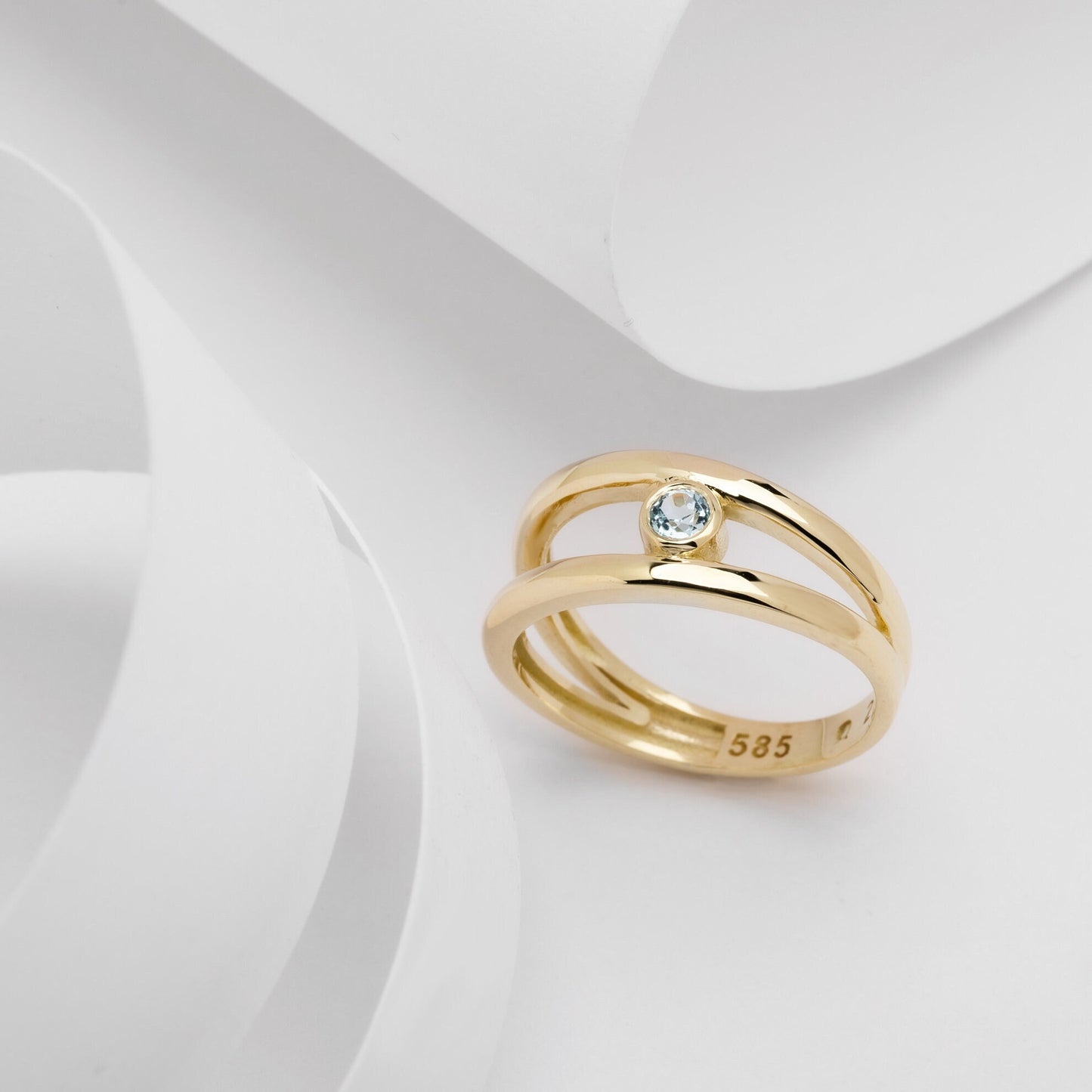 A handmade, double-row birthstone ring set in 14k gold with a bezel setting.