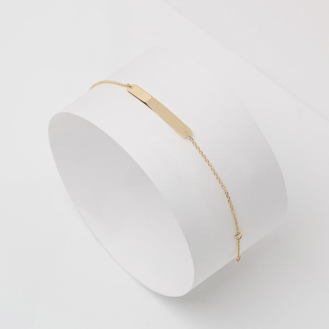 A delicate ID bracelet crafted in 14k gold, customizable for a personal touch.