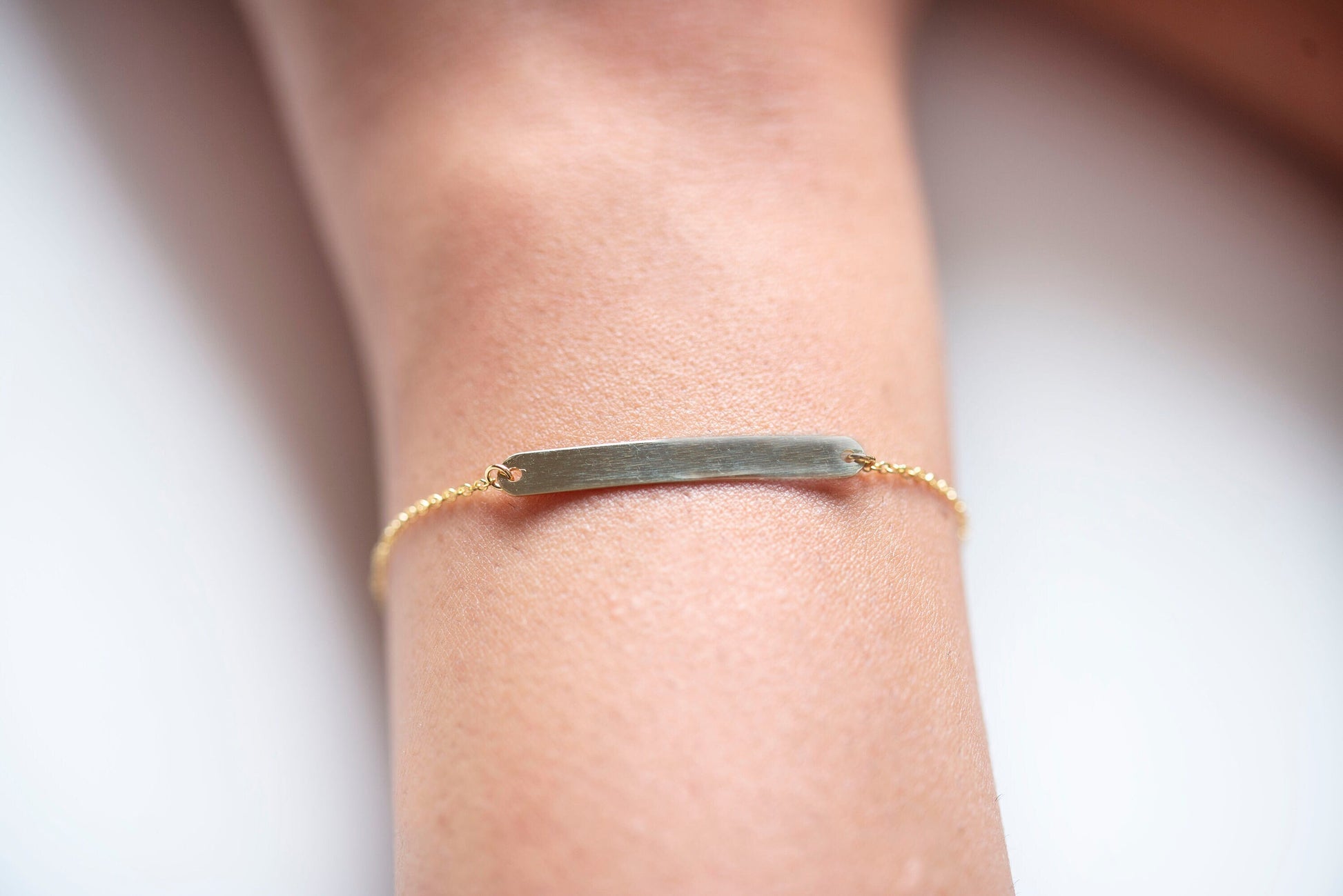 A delicate ID bracelet crafted in 14k gold, customizable for a personal touch.