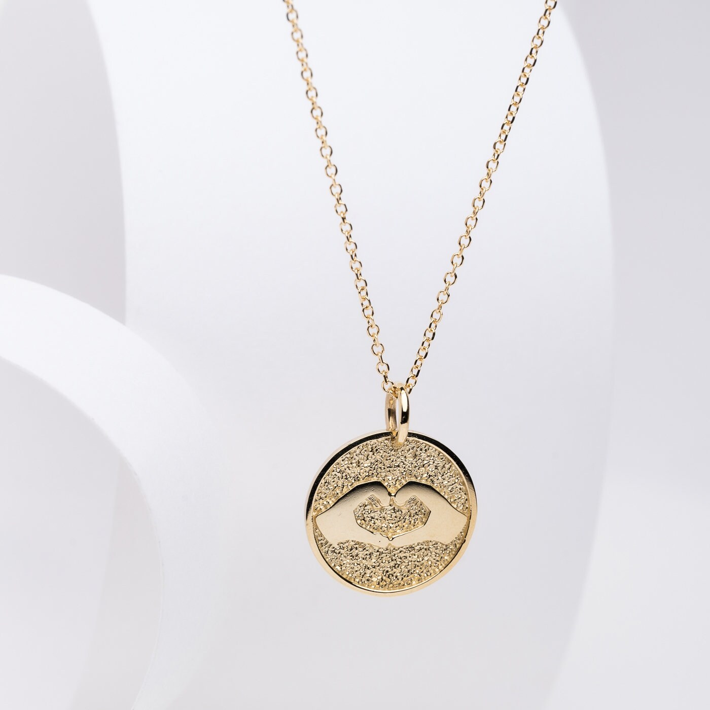 Hand Gesture Heart Necklace in 14k solid gold for women with free engraving on the back side.