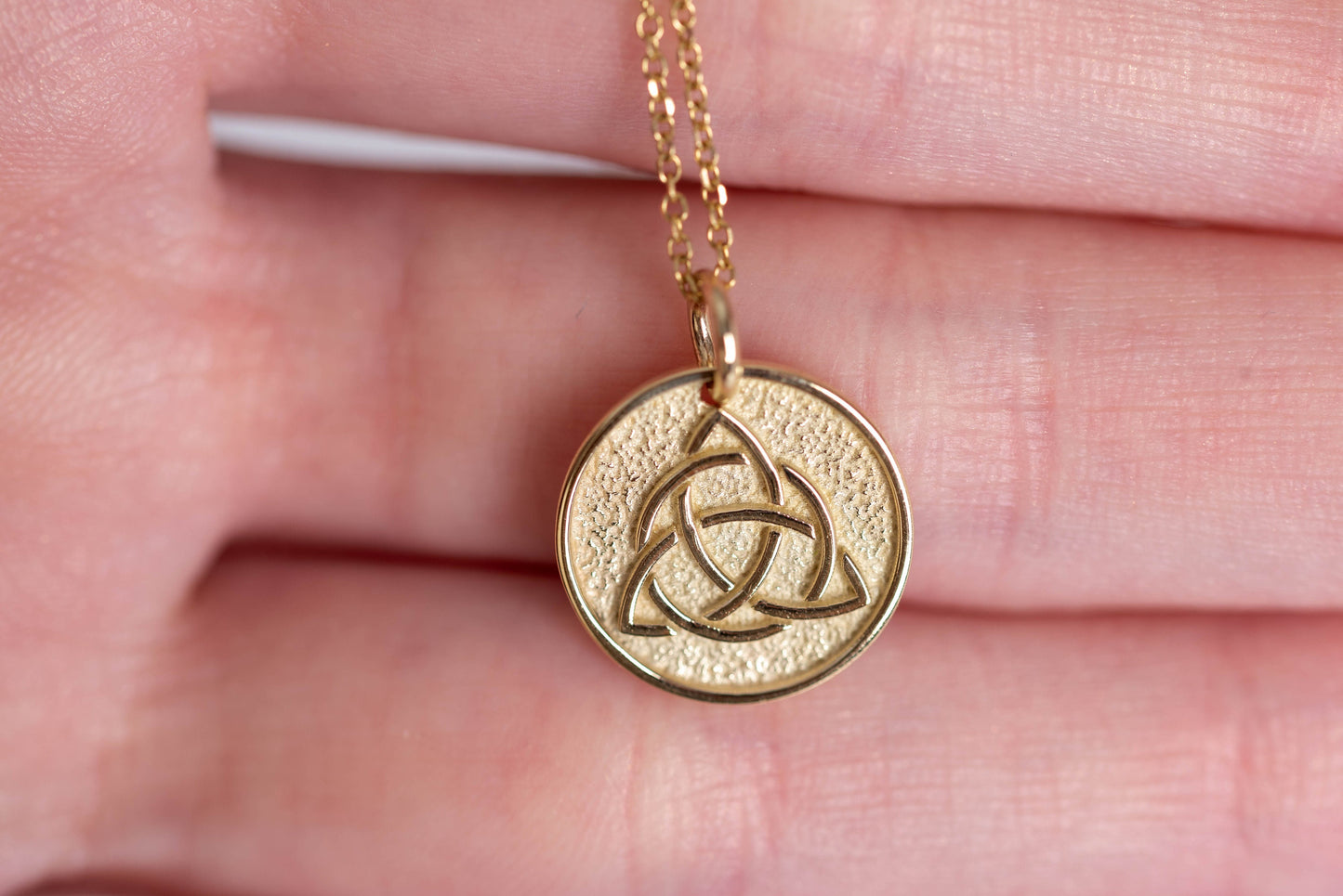 Trinity Knot Necklace in 14k solid gold for women, with complimentary engraving on the reverse side.