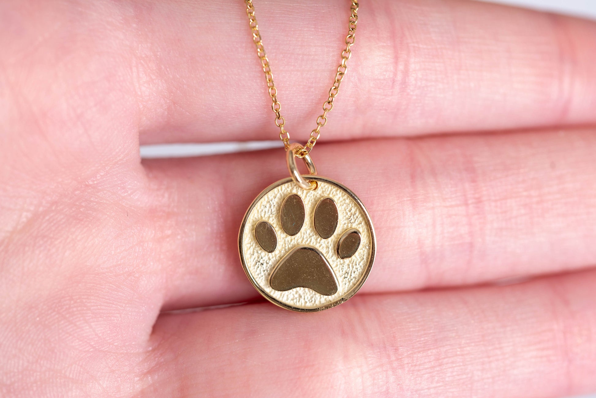 Paw Pendant crafted in 14k solid gold, complete with complimentary engraving on the reverse side.