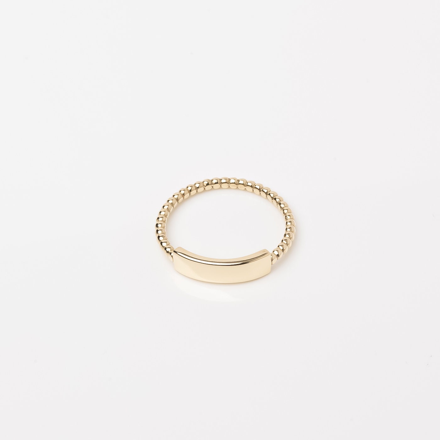 A personalized bar ring for women, crafted in 14k gold and featuring a beaded design.