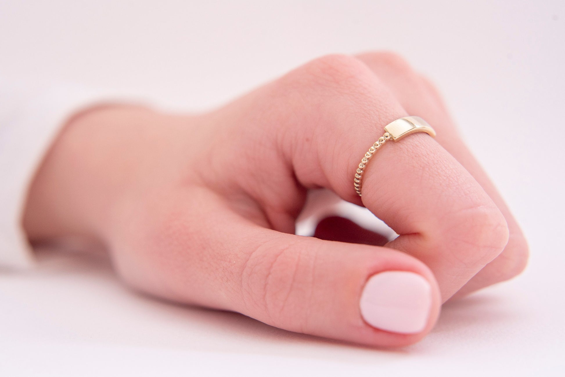 A personalized bar ring for women, crafted in 14k gold and featuring a beaded design.