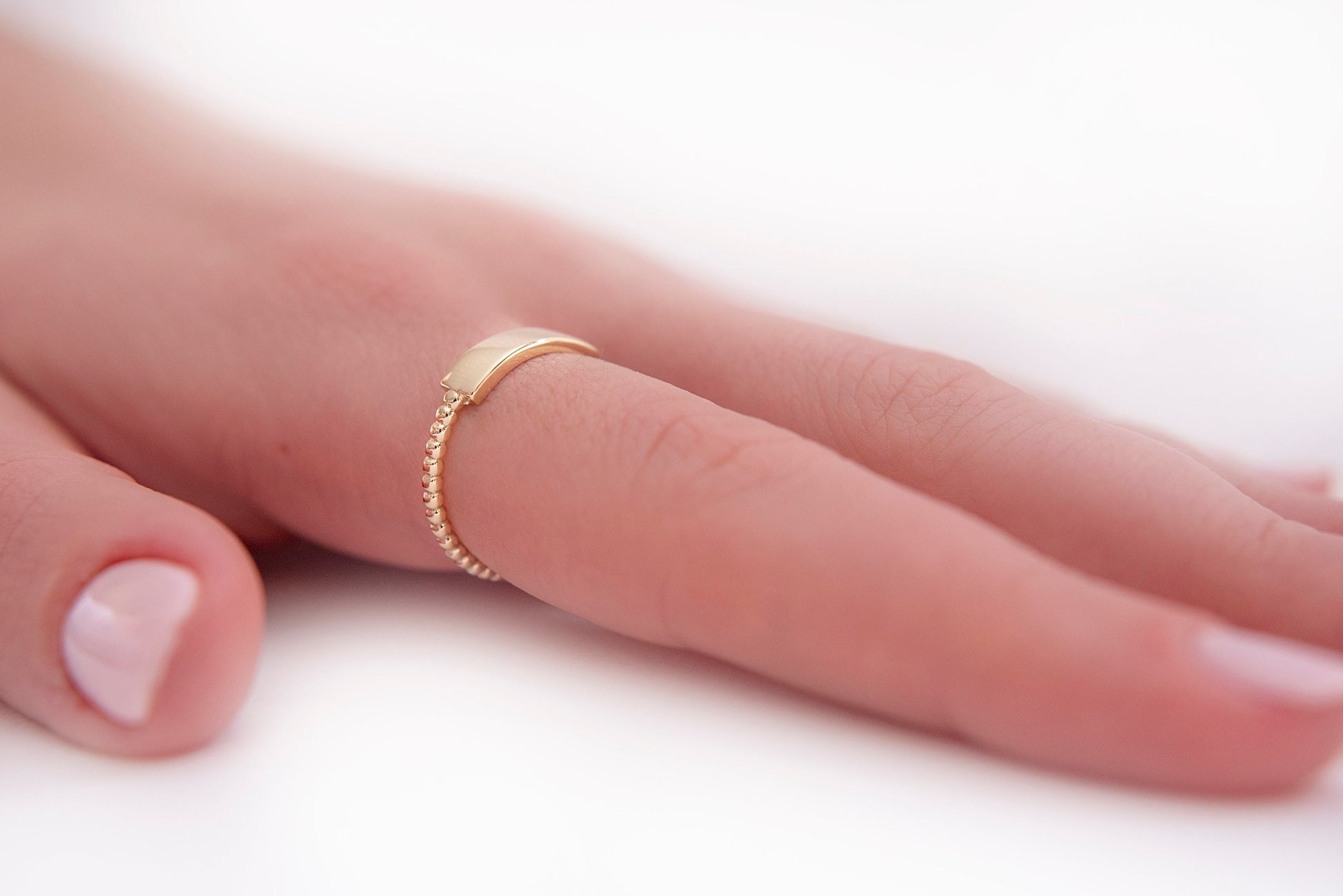 A personalized bar ring for women, crafted in 14k gold and featuring a beaded design.